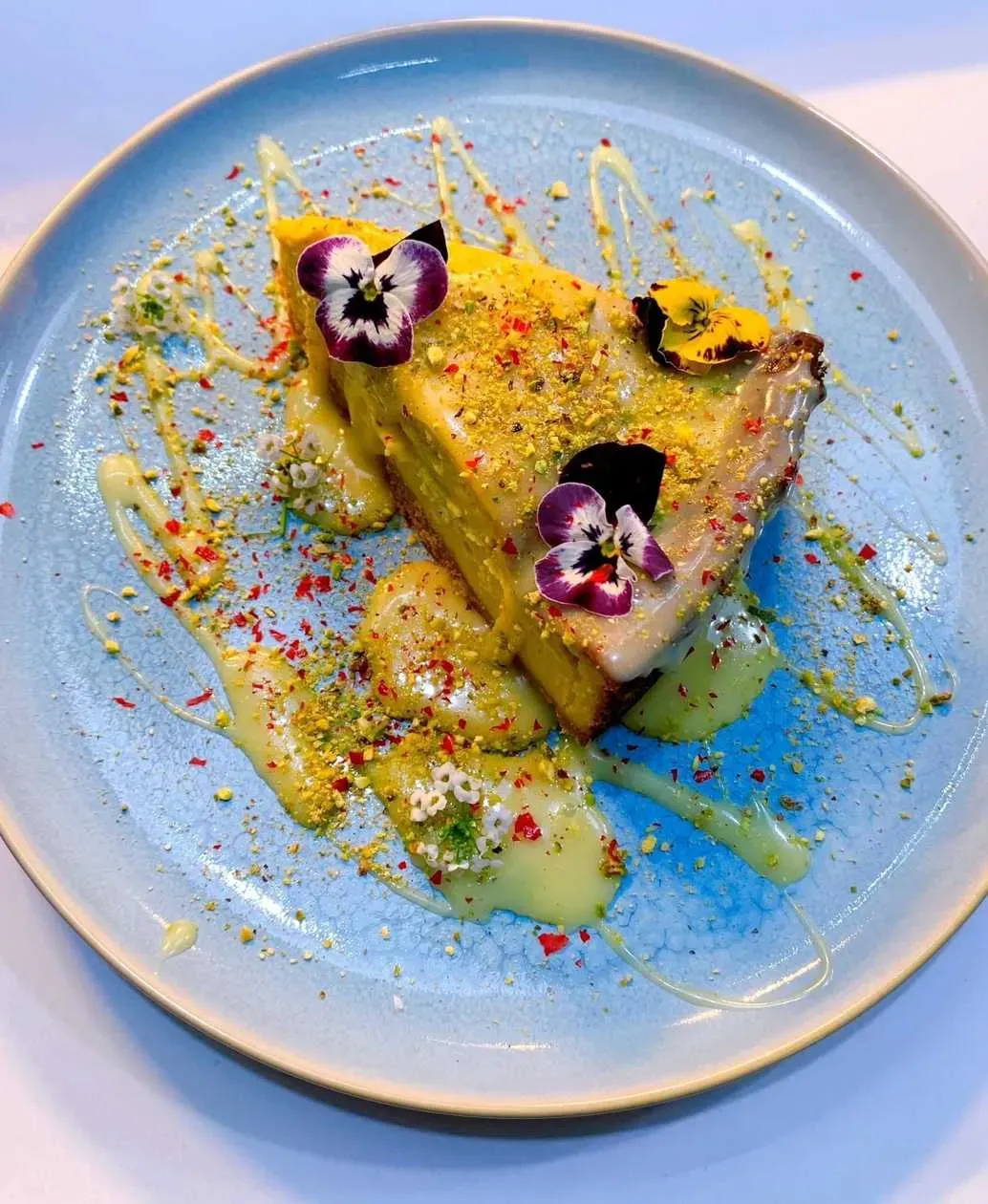 Mango Cheesecake with White Chocolate and Pistachio Powder