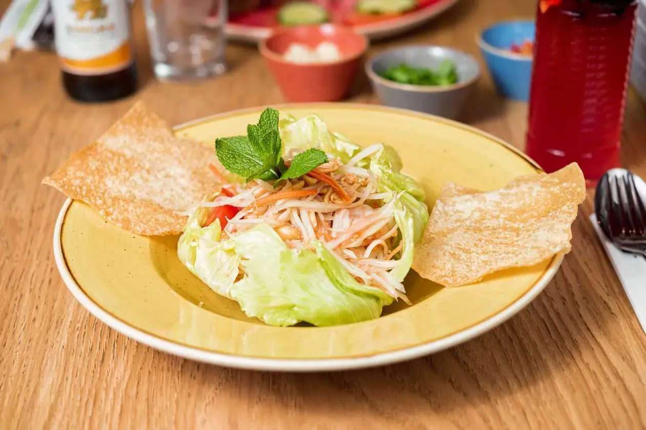 Green Papaya Salad with Shrimps, Cherry Tomatoes, Peanuts and Chili Dressing