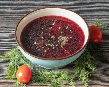 Red borscht with ravioli with mushroom
