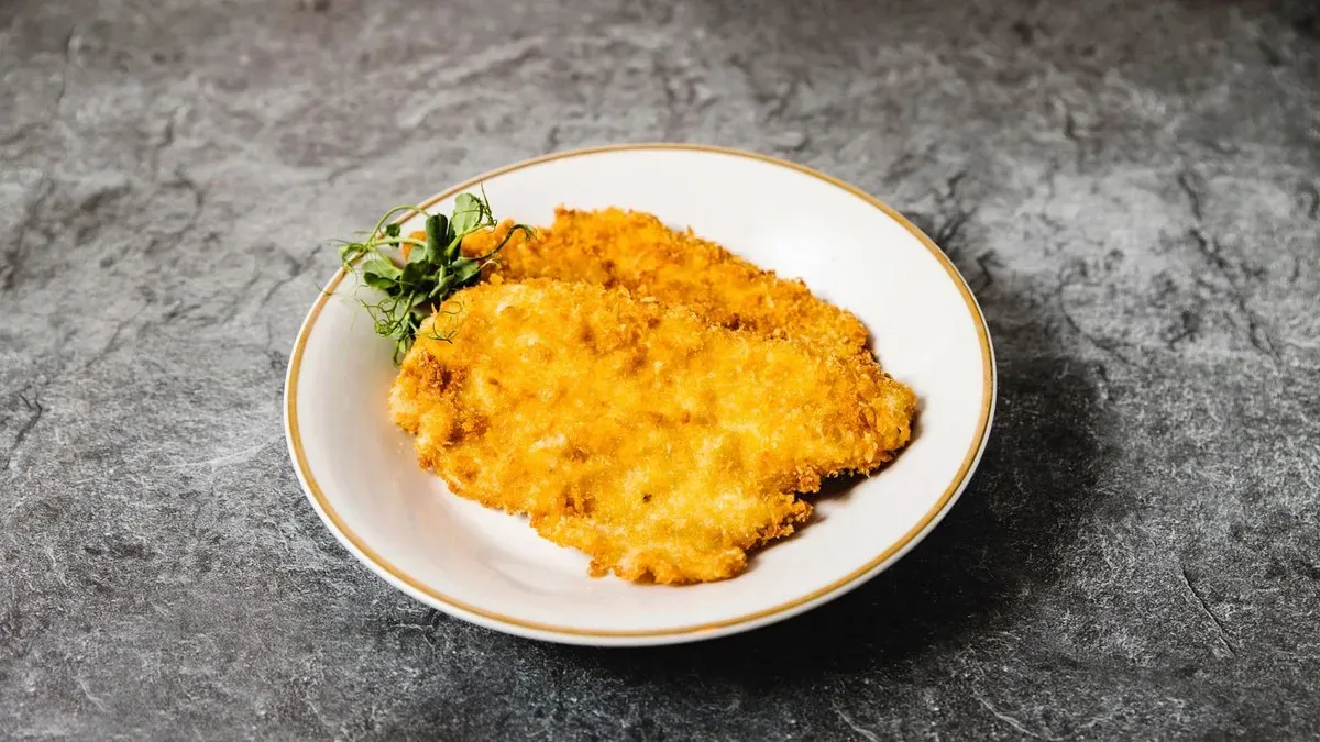 Pankómorzsás rántott  csirkemell 2 szelet körettel vegyes friss salátával